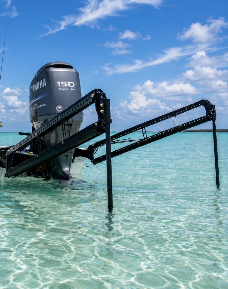 Black Power-Pole dual anchors deployed on a boat at sunset